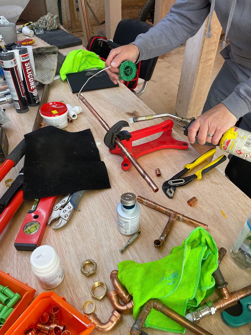 Learner soldering copper pipe on the 3-Day Complete Plumbing Course at Deeside